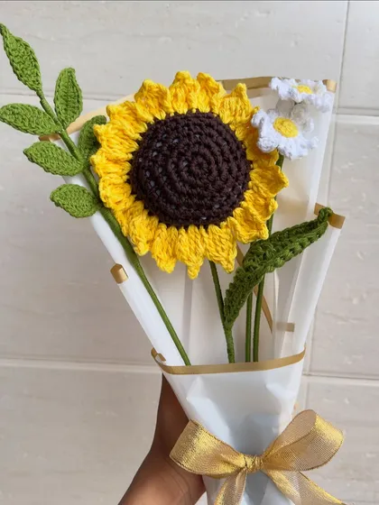 Brighten up any room with our handmade crochet sunflower and daisy bouquet. These "forever flowers" are crafted with vibrant yellow and white yarn, complete with detailed green leaves, and wrapped beautifully for the perfect, lasting gift.