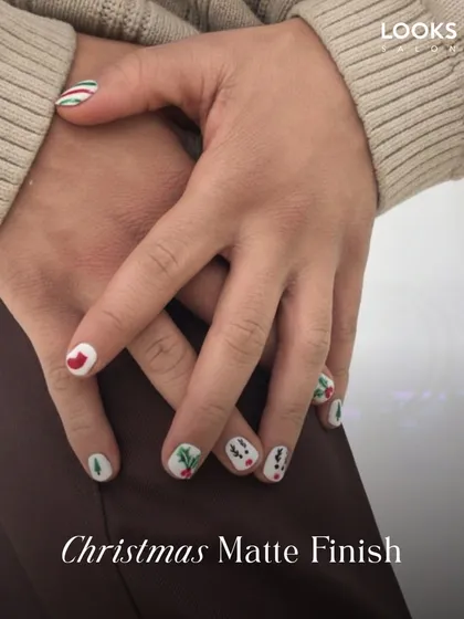 Getting into the festive spirit with a Christmas Matte Finish manicure. This design features fun, hand-painted holiday motifs on a clean white base, proving that seasonal nail art is for everyone.