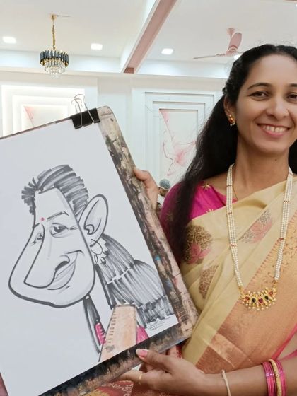 A teacher in a beautiful saree with her caricature. These events are a great way for staff to relax and have fun.
