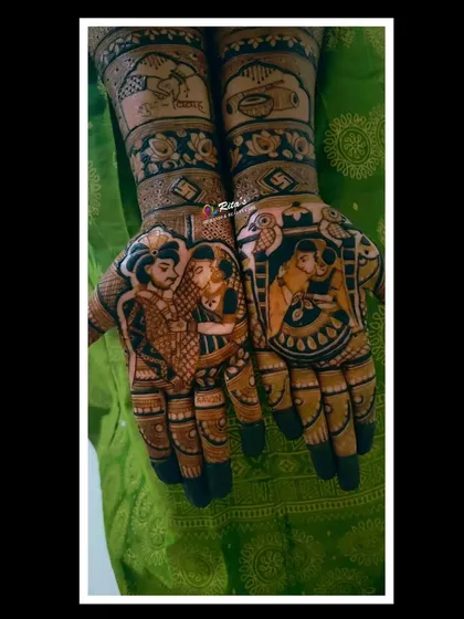 A close-up of the palms for a Maharashtrian bride, showing a traditional couple portrait on one hand and a romantic dance pose on the other, surrounded by intricate patterns.