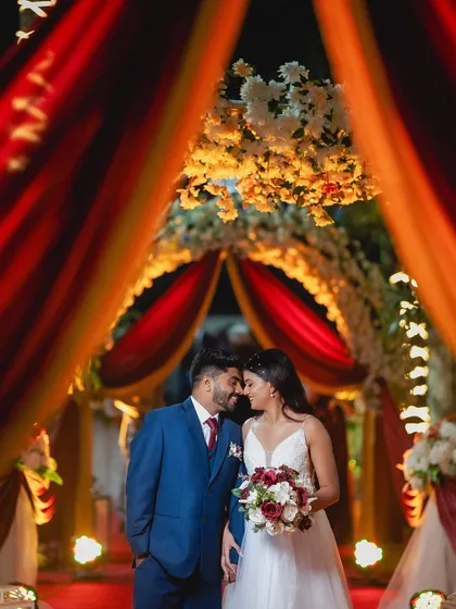 A quiet moment for the couple under a beautifully decorated archway at their reception. I focus on using ambient light and decor to frame these romantic wedding portraits.