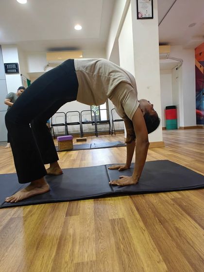 Each student's Chakrasana is unique. My role is to guide them in finding their best expression of the pose, focusing on opening the chest and maintaining steady breath.