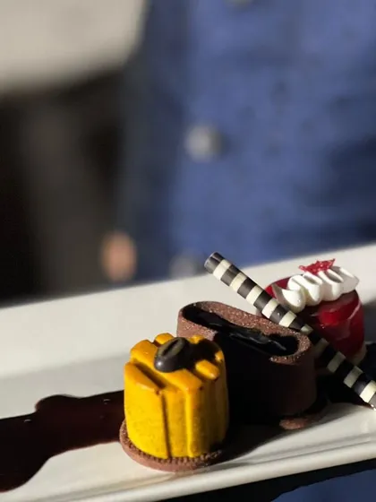 Dessert should be a work of art. This plated trio, featuring chocolate, fruit, and coffee elements, is designed for a sophisticated sit-down dinner where every course is a statement.