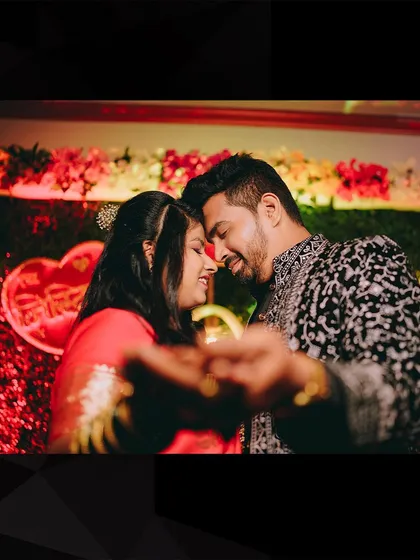 A romantic reception photo with a creative touch. We captured the couple's embrace through their intertwined hands, focusing on their connection.