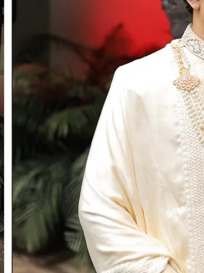 A detailed shot of the groom's sherwani, focusing on the texture of the silk and the craftsmanship of the embellished collar and buttons.