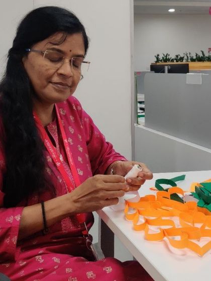 Carefully crafting each link of the paper chain during our office decoration activity.