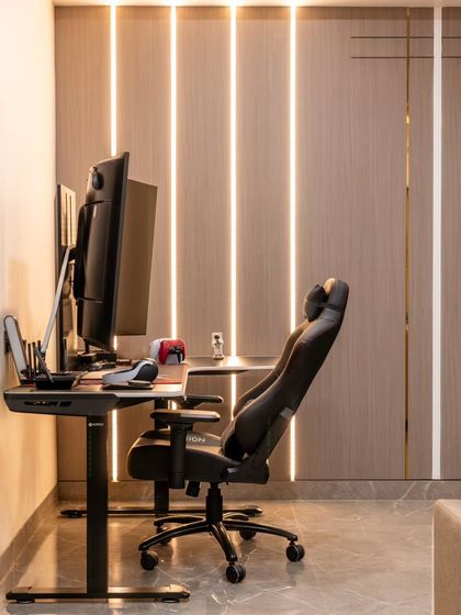 A closer look at the dedicated gaming and work-from-home zone in the multi-purpose living room. We used vertical profile lights set into a paneled wall to create an immersive, futuristic ambiance that can be customized for work or play.