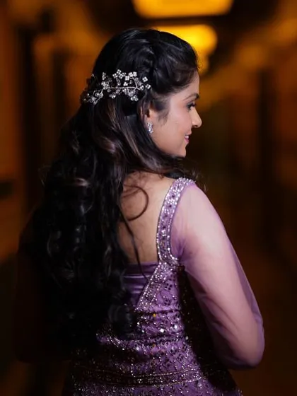 A beautiful shot of the bride's hairstyle for her engagement. The side-swept curls were adorned with a delicate, sparkling hair accessory.