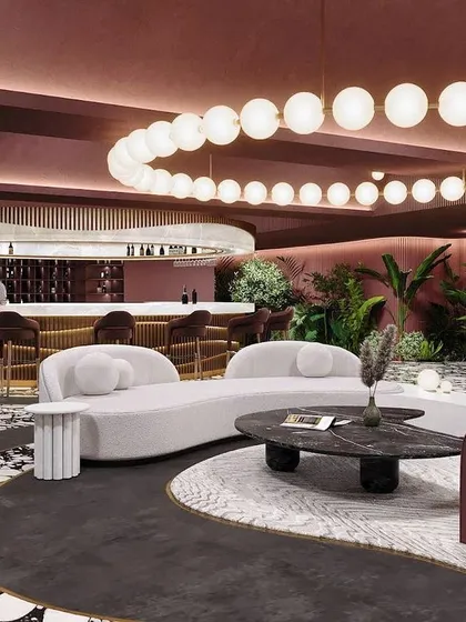 The bar area of "Spiced Martini," with its curved counter and dramatic circular chandelier, is the heart of this exuberant and luxurious space.