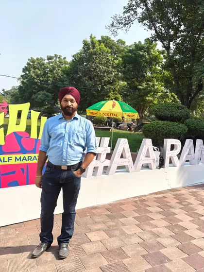 A member posing at the expo. The vibrant decorations add to the festive atmosphere.