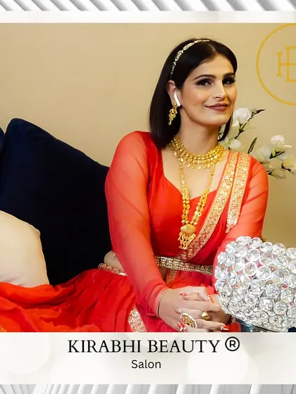 The full look of a client dressed in a traditional red outfit. The makeup is elegant and timeless, perfect for a family function or festival.