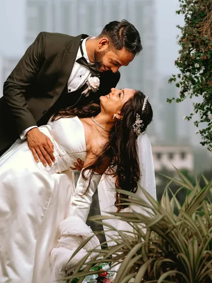 A classic dance pose against an urban backdrop. This portrait combines traditional romance with a modern setting, capturing a sweet, intimate moment.