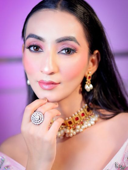 An extreme close-up focusing on the eye makeup, lipstick, and jewelry details, perfect for a beauty editorial.