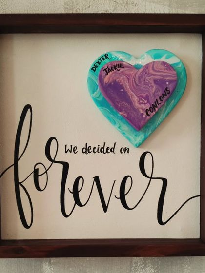 "We decided on forever." This custom anniversary gift features a unique fluid-art heart with the family's names, making it a deeply personal and artistic keepsake.