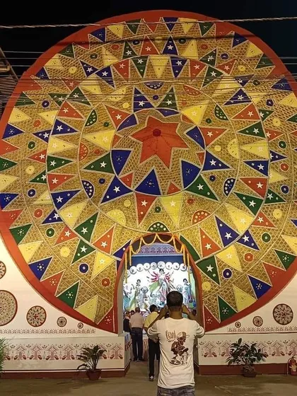The grand entrance to the Durga Puja pandal, framed by the world's largest 'Japi' that we created for the event.