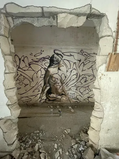 Another angle of the "Views" piece, seen through a hole in the wall. The framing adds another layer to the artwork, like you're discovering a hidden secret.