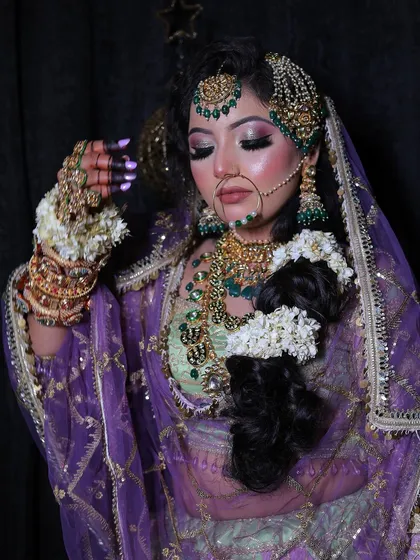 A close-up of the beautiful makeup and jewellery for the pastel lehenga look. The green beadwork on the jewellery perfectly matches the outfit.