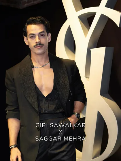 This shot highlights the clean lines and perfect fit of the tailored black suit. It’s a testament to the power of a well-crafted garment to convey effortless style and confidence.