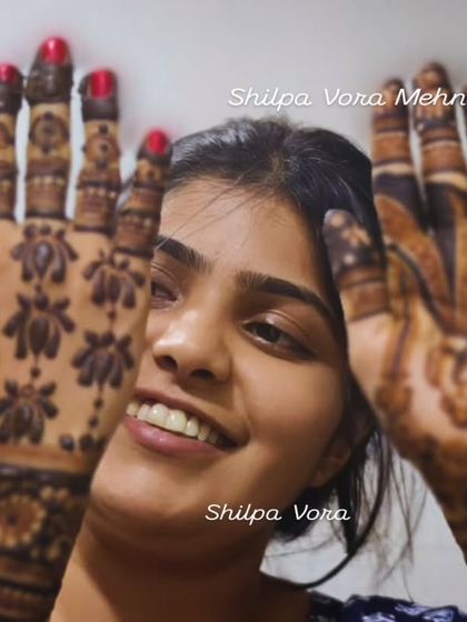 A happy client showing off her full-hand lotus 'jaal' design.