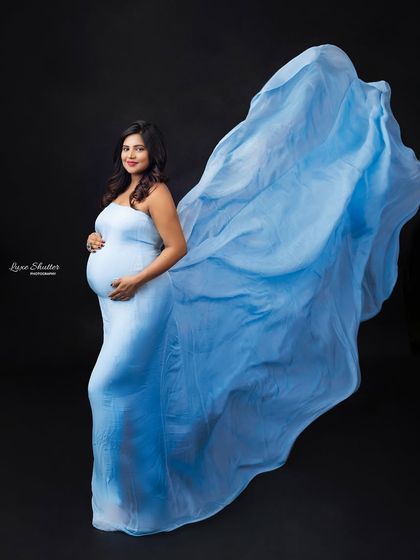 A classic fabric toss with a beautiful light blue gown. This technique adds movement and grace, turning a simple portrait into something truly dynamic and eye-catching.