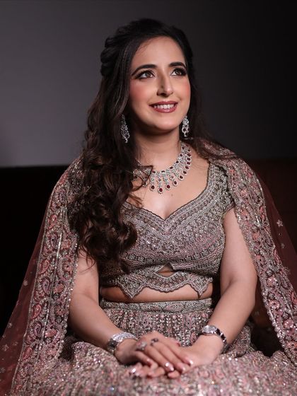 A lovely seated portrait of the bride-to-be. Her soft glam makeup with a hint of shimmer on the eyes looks perfect with her ornate lehenga.