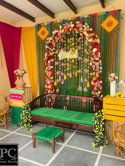 A full view of the rustic Mehndi decor, showing how I used cane chairs and wooden crates to complement the main swing and create a cohesive, earthy look.