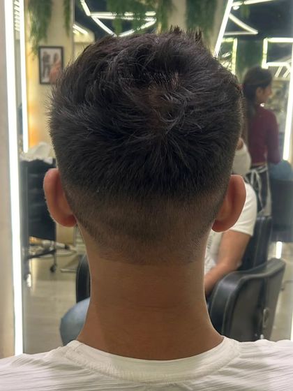 The back of a men's haircut, showing a clean fade and textured top for a dapper, modern look.