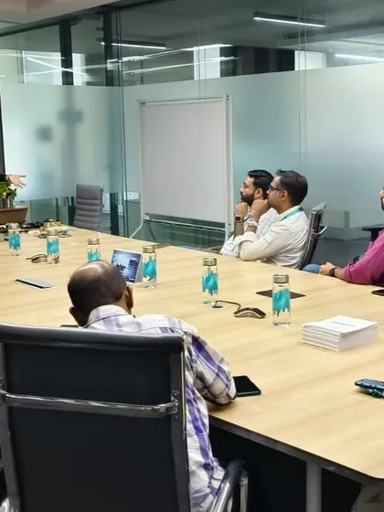 Leading a discussion with a team in a boardroom. My workshops are highly interactive, encouraging questions and conversations to ensure the content is relevant and impactful for everyone in the room.