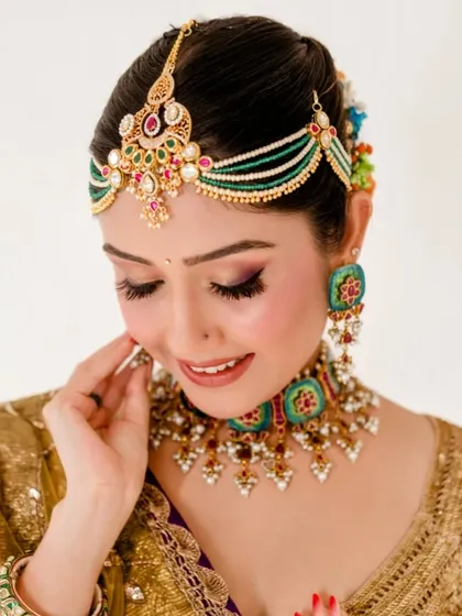 The client's complete look, from the detailed makeup to the traditional floral bun. This is a perfect example of a classic Indian bridal style.
