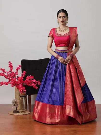 A royal blue and red half-saree lehenga, a stunning combination that is sure to turn heads.