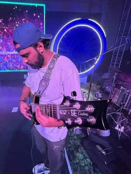 Our guitarist, focused on his craft. There's no 'I' in this team, just a bunch of guys focused on making great music.