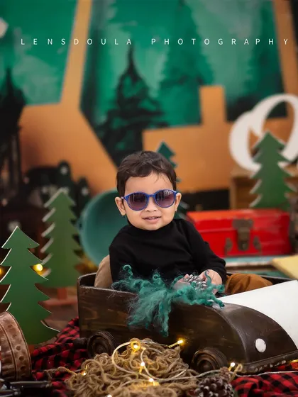 This little camper is too cool for school. The sunglasses add a fun, modern twist to our rustic woodland camping theme for his first birthday shoot.