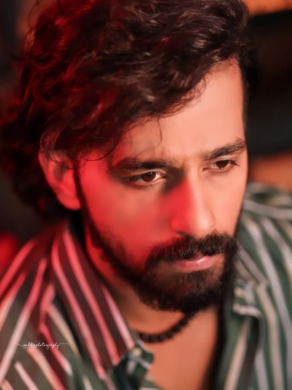 A collection of indoor portraits of an actor in a stylishly casual striped shirt. The moody lighting of the cafe setting adds a cinematic and modern feel, perfect for a character portfolio.