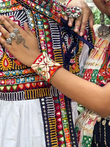 It's the small details that make a couple's outfit special. Here you can see the matching embroidery and shell-work on the cuffs, tying their two unique outfits together.