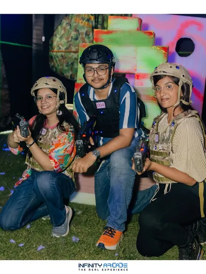 Three players geared up and ready for a laser tag battle at an outdoor event. My setup is fully mobile, allowing me to create an arena on grass, in a hall, or anywhere you need it.