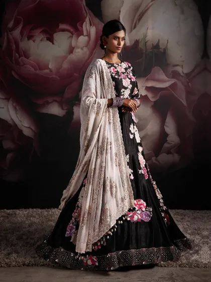 In my fashion realm, each garment becomes a masterpiece. This black floral lehenga is designed to leave a mark on hearts and souls, embodying the essence of pure elegance for a sangeet or reception.