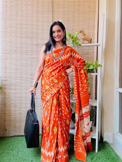 This orange ikat print pre-stitched saree is a vibrant and energetic choice. It's perfect for adding a pop of color to your workwear.