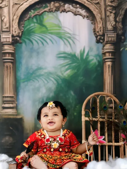 A joyful smile from our little Radha, capturing a moment of pure happiness and charm.