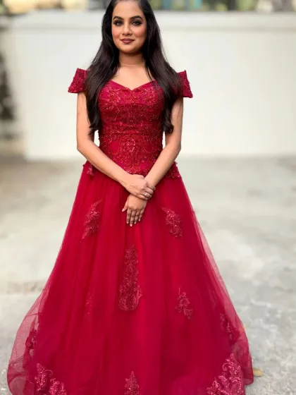 A full-length view of the red gown. The entire look is a statement of confidence and glamour, perfect for making a grand entrance.
