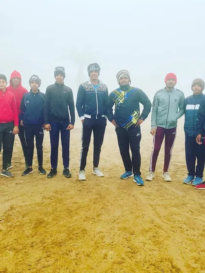 The team stands together during a foggy morning session, ready to start their training day.