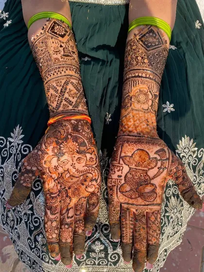 A clear, top-down view of the Ganesh and kalash designs, showcasing the symmetry and detail of this festive mehndi.
