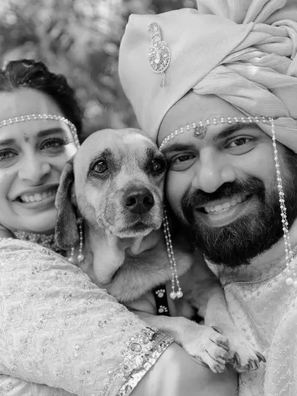 A wedding is a family affair, and for this couple, that included their beloved dog, Fubu. This happy black and white family portrait is a heartwarming reminder that love is a four-legged word.