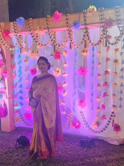 A guest posing at the wedding venue, with her makeup looking flawless even in the evening event lighting.