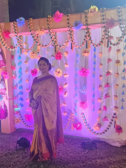 A guest posing at the wedding venue, with her makeup looking flawless even in the evening event lighting.