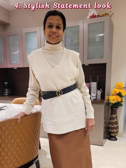 A stylish statement look for the fall and winter season, featuring a turtleneck, sweater vest, and satin skirt.