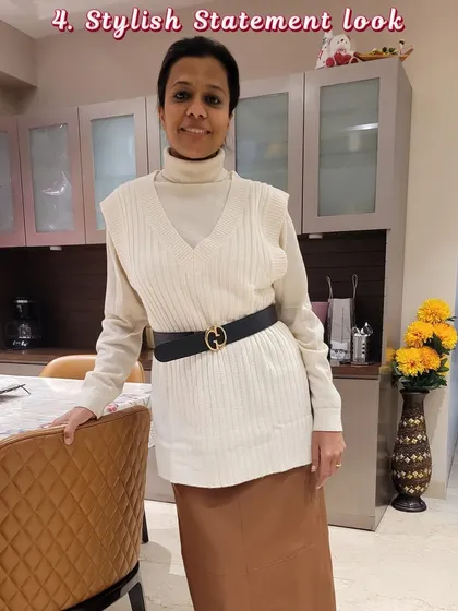 A stylish statement look for the fall and winter season, featuring a turtleneck, sweater vest, and satin skirt.