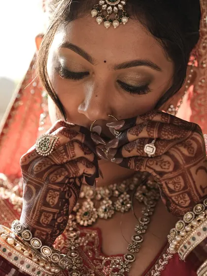 A beautiful bridal portrait focusing on the hands. The rich, dark henna stain adds to the overall beauty and elegance of the bride's look.