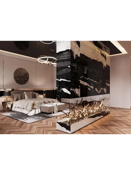 We designed this master bedroom to be an opulent retreat, featuring a stunning floor-to-ceiling marble accent wall that houses a modern fireplace. The herringbone wood flooring and layered textiles add warmth and texture to this luxurious space.