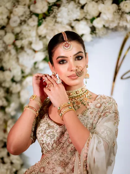 A powerful pose showing the final details of the makeup and jewelry. Learning to create these picture-perfect moments is a key part of becoming a professional makeup artist.