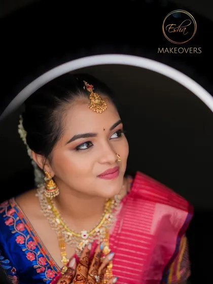 A creative portrait of a bride, showcasing her flawless muhurtham makeup. The ring light highlights the radiant skin finish and the perfectly blended eyeshadow.